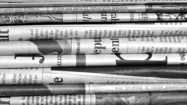 A stack of folded newspapers